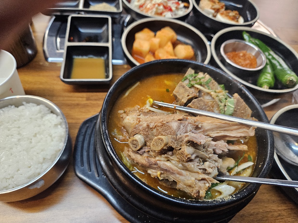 Korean gamjatang pork bone stew with side dishes near Incheon Airport
